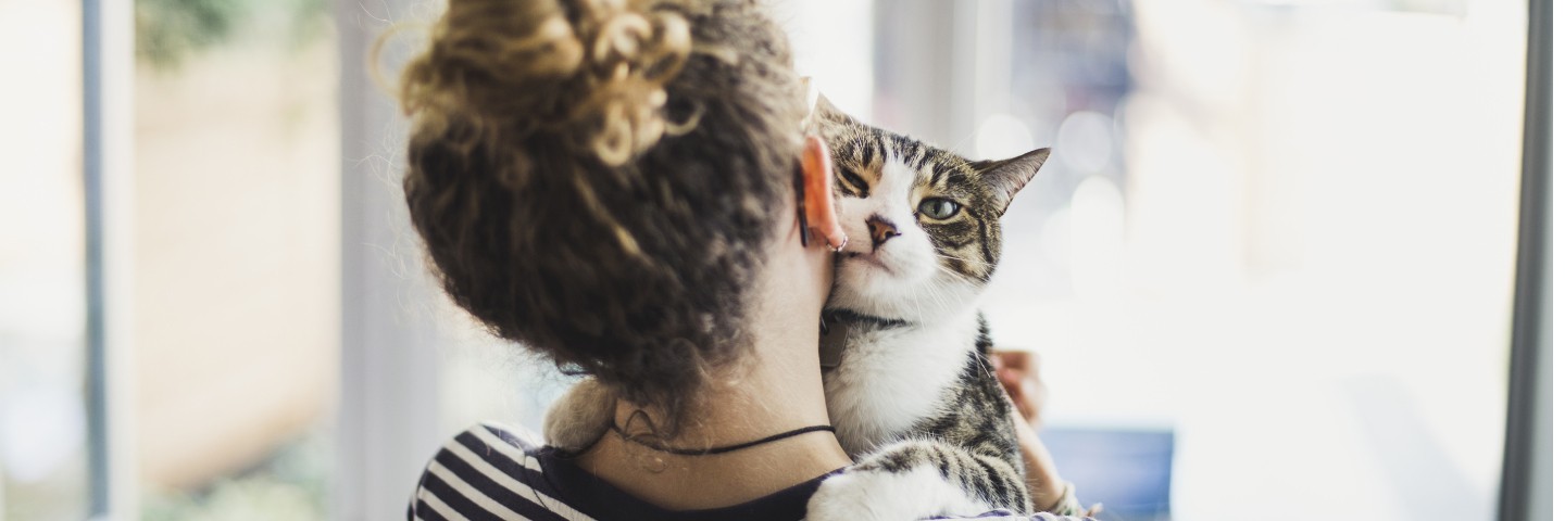 woman cuddle with cat
